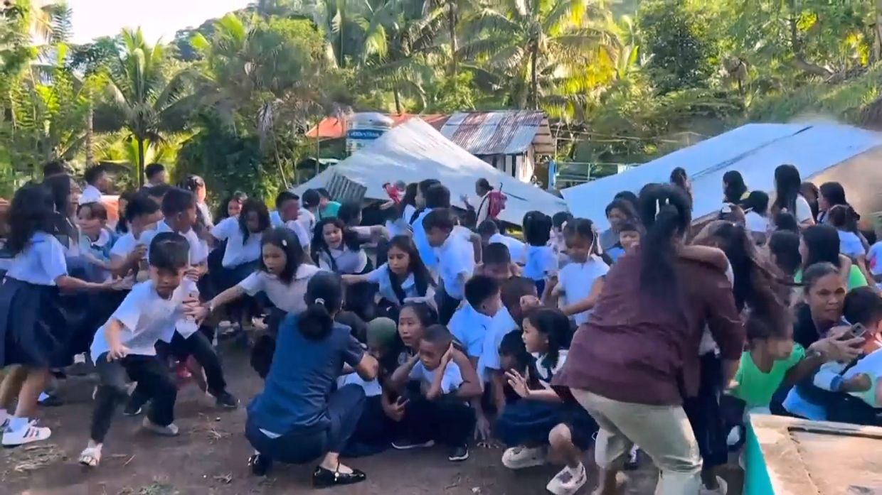 This image made from video provided by DepEd Mahayahay Elementary School shows school children reacting as a canopy roof collapsed, following the powerful earthquake in Malita, Davao Occidental province, Philippines. - DepEd Mahayahay Elementary School via AP