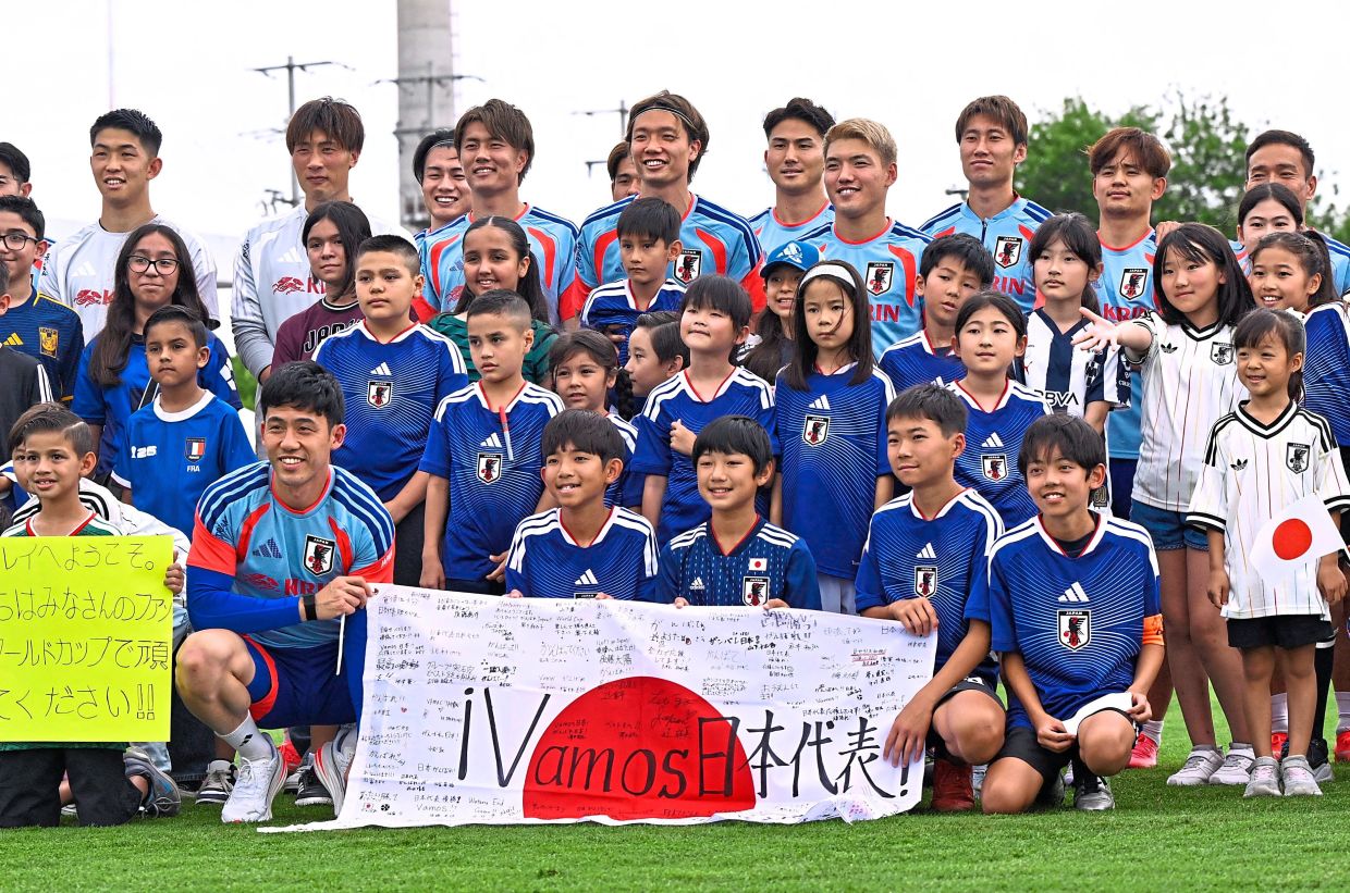 Japan football players pose for a photo with fans during training session at Tigres Training Centre, Monterrey in Mexico. Photo: Reuters 