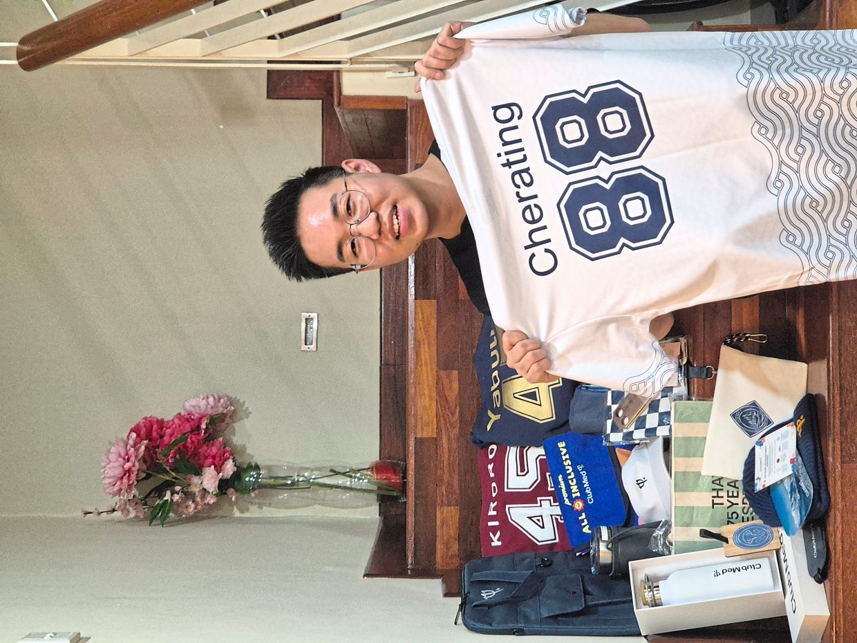 Lee with some of his Club Med merchandise collection. — SAMUEL LEE CHUN ZHEN