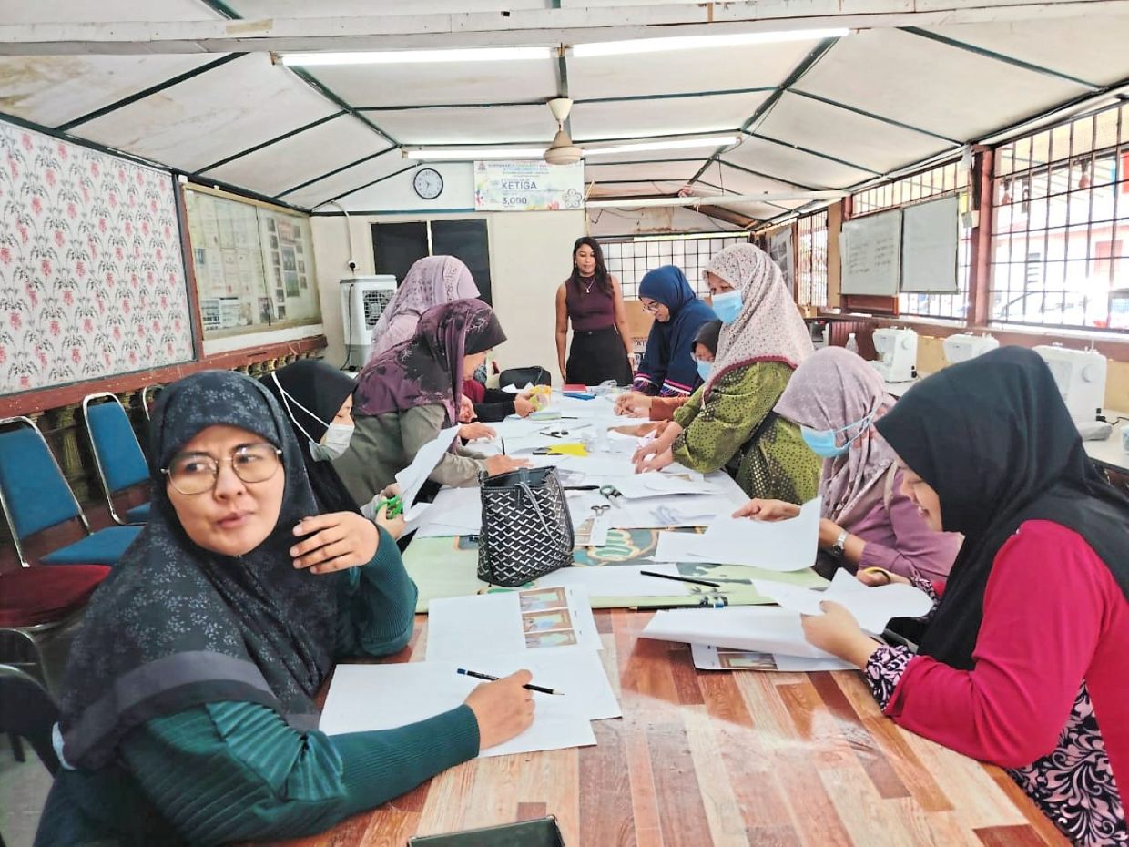 Participants working on sewing reusable sanitary pads during the workshop.