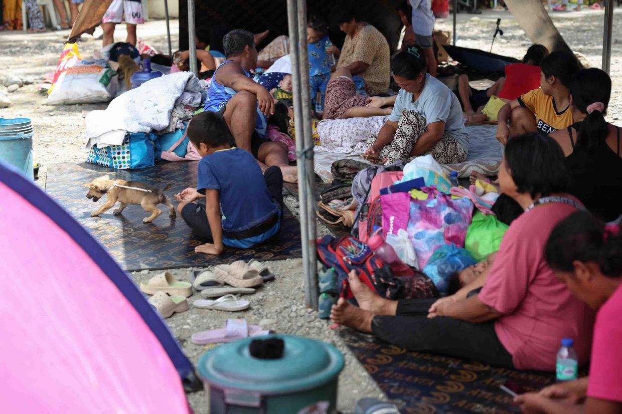 Residents taking shelter in a field at a municipal hall in Sarangani province on June 10, 2026. - AP