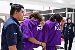 Two remanded over alleged assault on foreign national, property damage