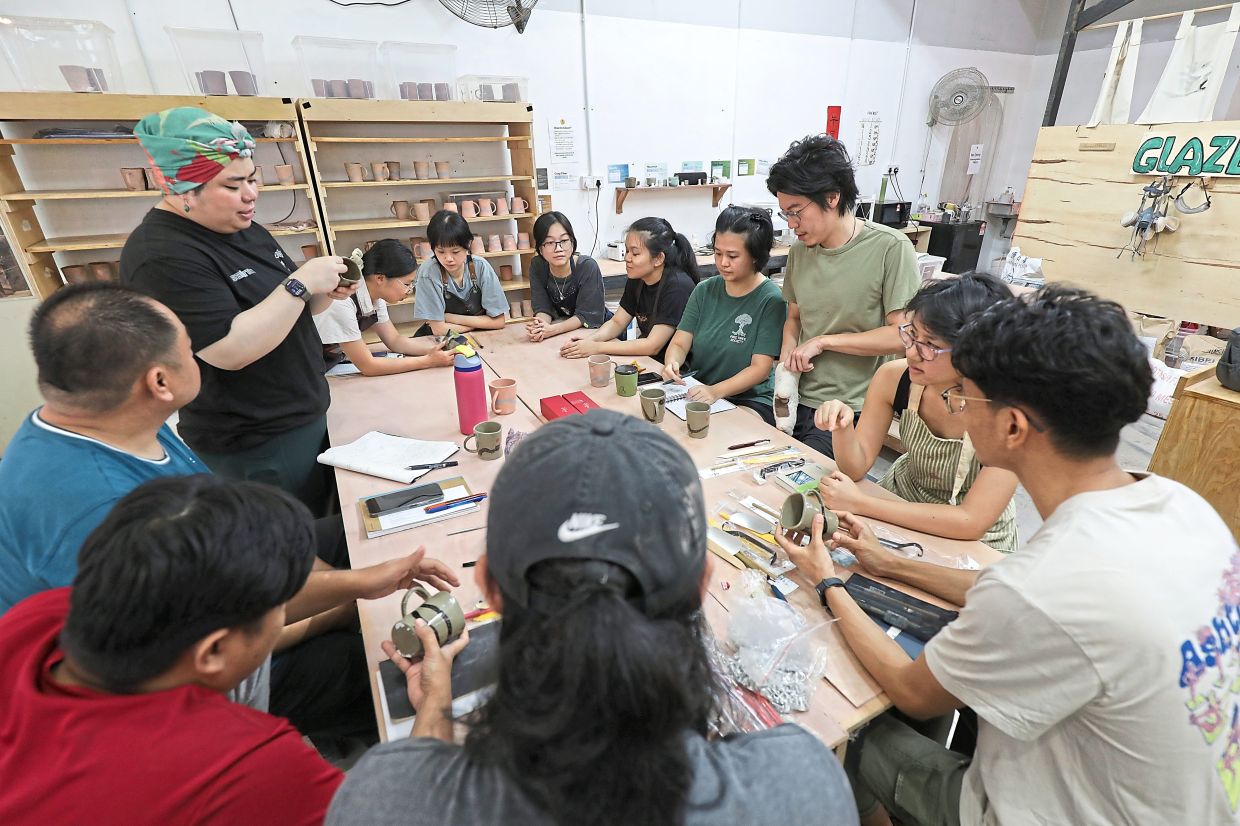 Students learn clay crafting skills during a hands-on training session at Friends Craft Cooperative.
