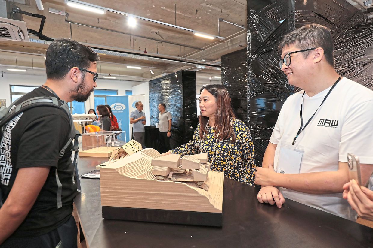 Architect Afi Jamalludin shares more about his social housing prototype to Yeoh (centre) and Beh (right) at MAW 2026 Kuala Lumpur.