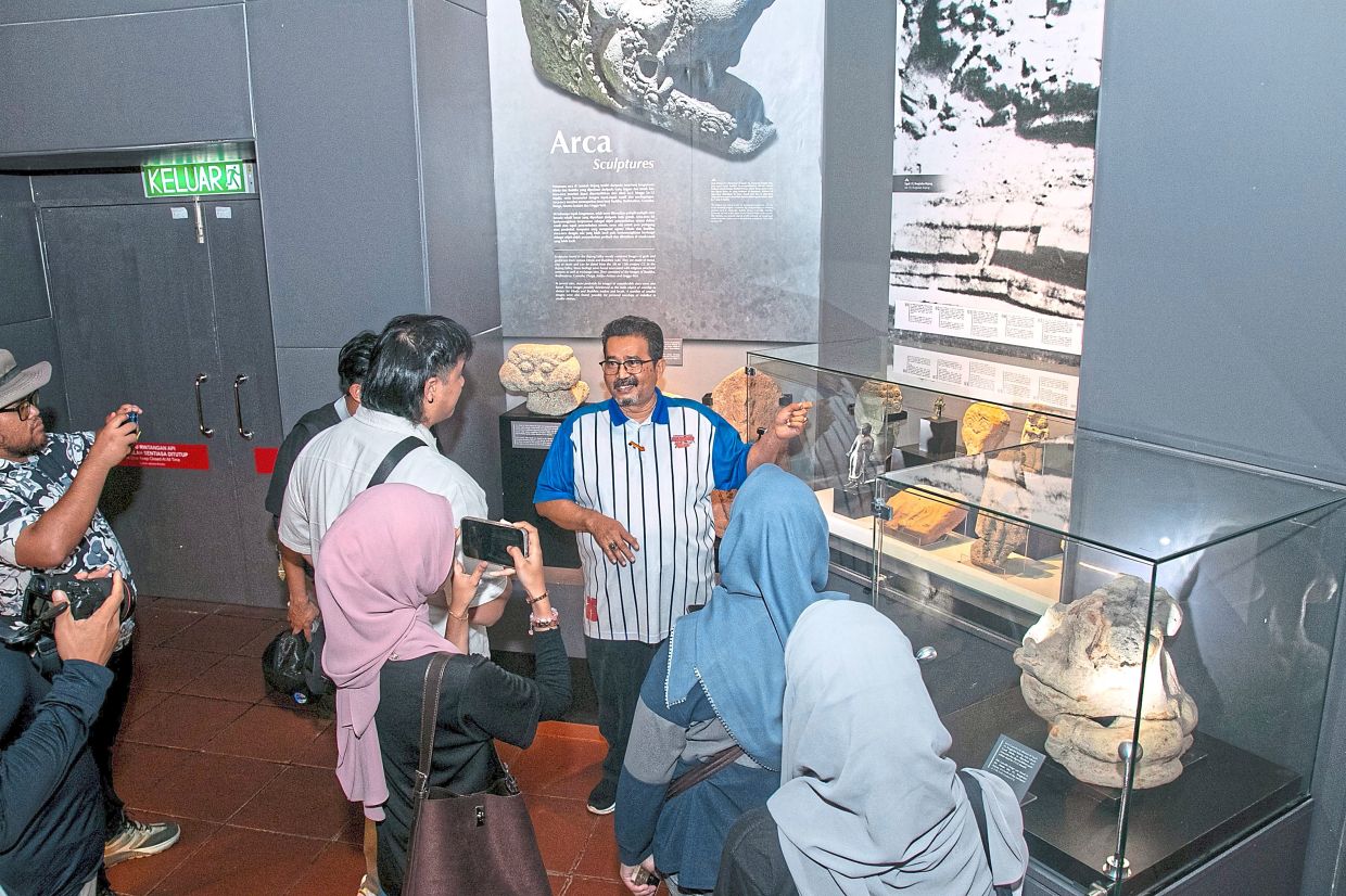 Visitors learning about the historical remains at the Bujang Valley Archaeological Museum.