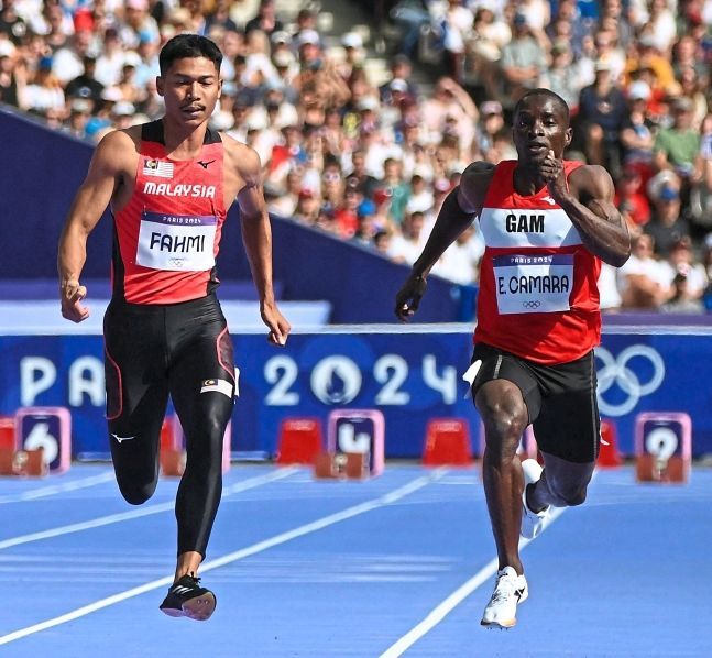 Working hard: Mohd Azeem Fahmi (left) says he still has plenty to improve to be one of the best sprinters in Asia. — AFP
