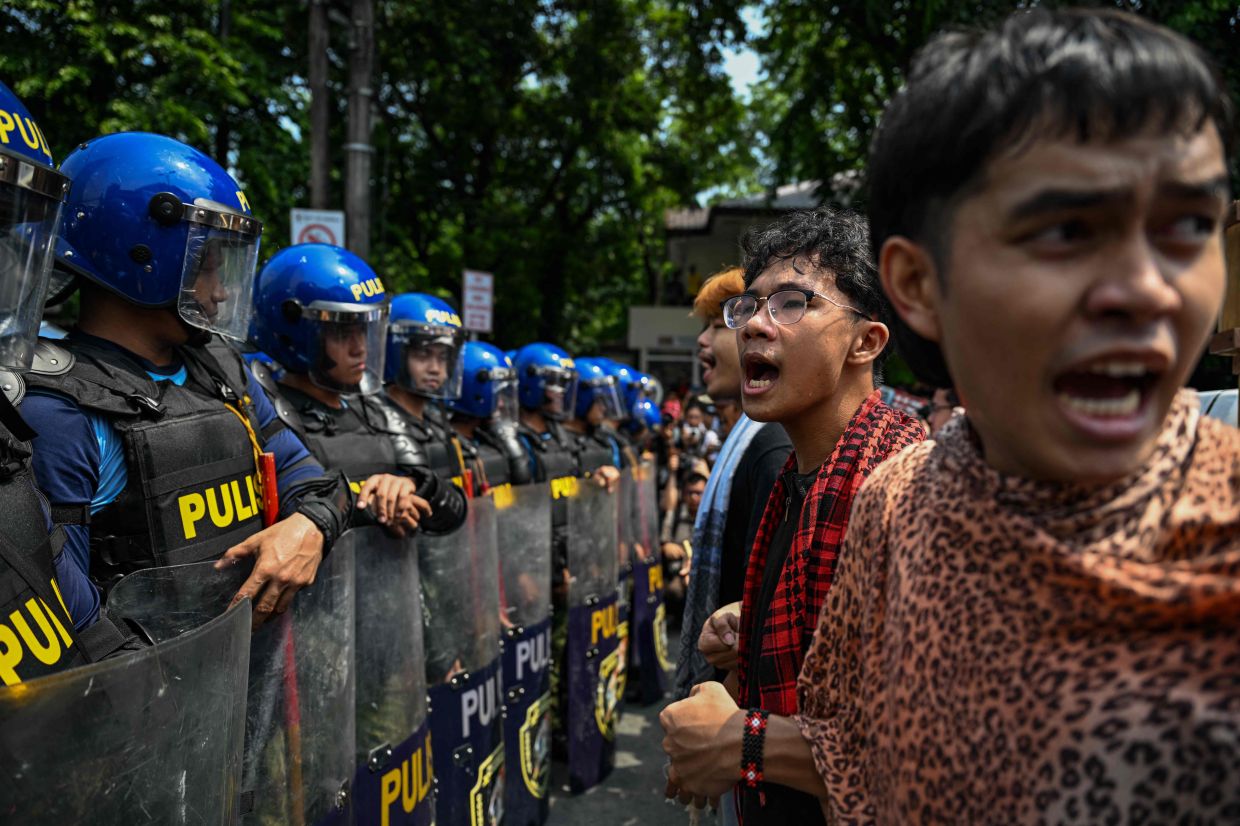 People face a line of police as they protest in Manila on Friday, June 12, 2026, to coincide with the country's Independence Day celebrations. -- Photo by Jam STA ROSA / AFP