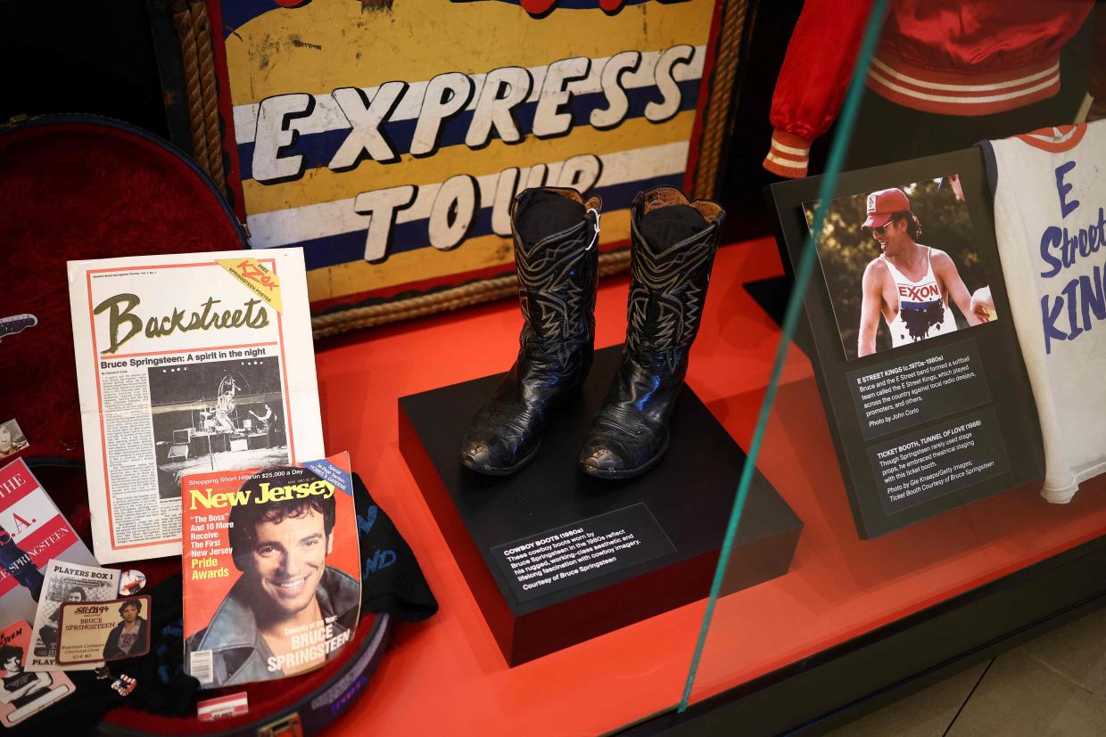 A pair of cowboy boots is displayed during a press preview of the 'Bruce Springsteen Center for American Music. — Photo: CHARLY TRIBALLEAU/AFP