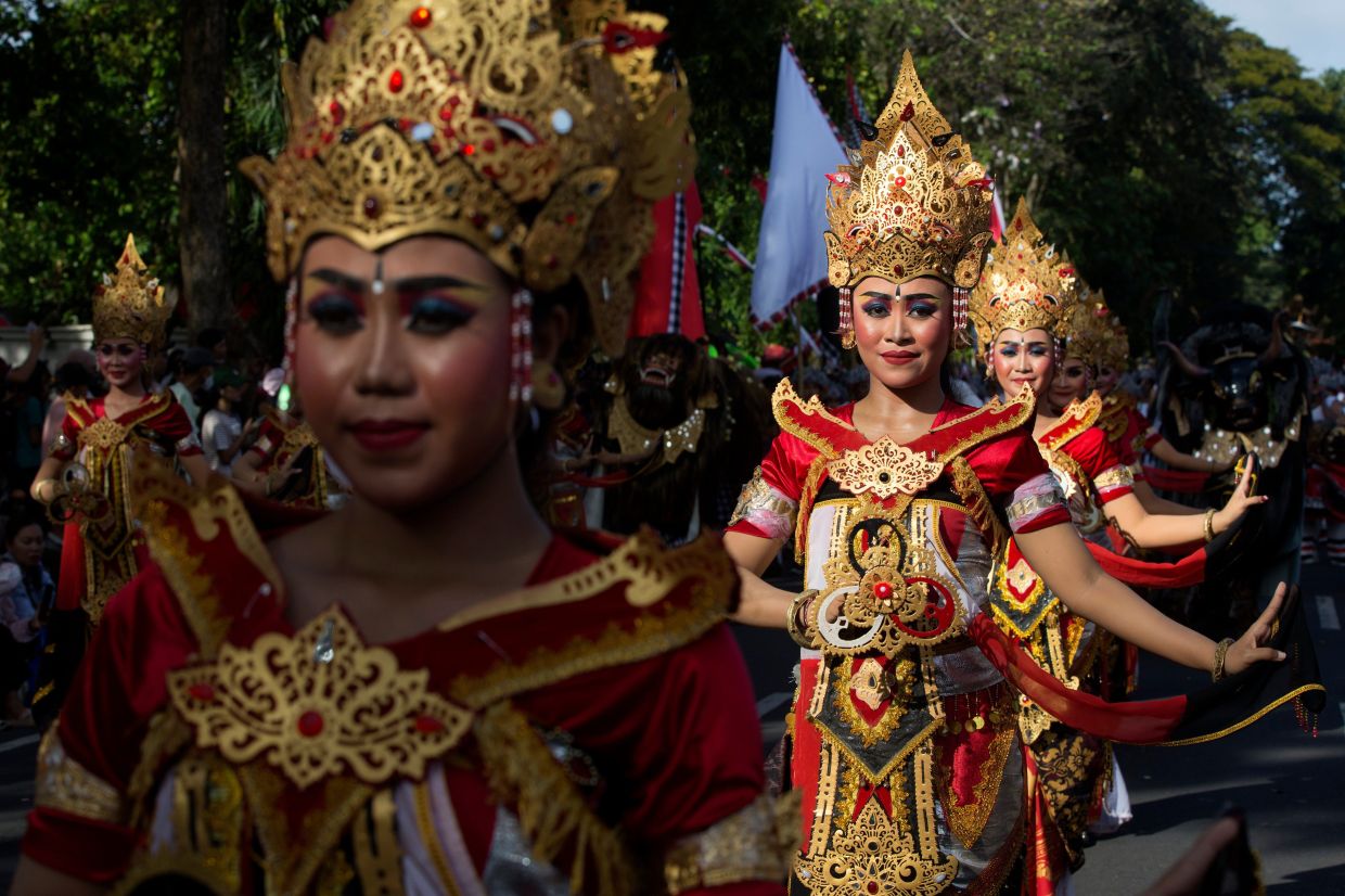 Dancers perform during a parade marking the opening of the annual Bali Arts Festival in Denpasar, Bali, Indonesia, on Saturday, June 13, 2026. AP Photo/Firdia Lisnawati