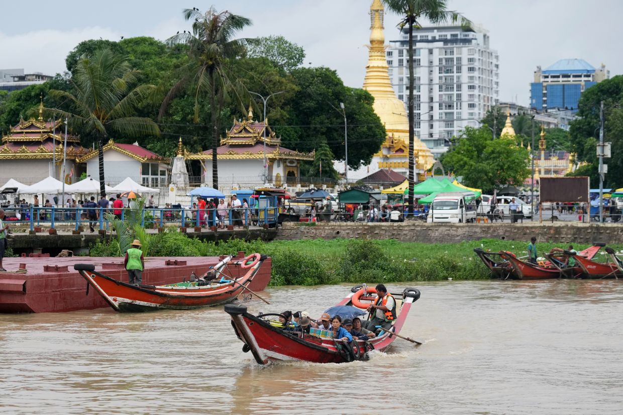 Passengers ride a ferry boat to cross Yangon river in Yangon, Myanmar. - AP Photo/Thein Zaw