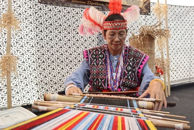 A participant demonstrates traditional weaving techniques.