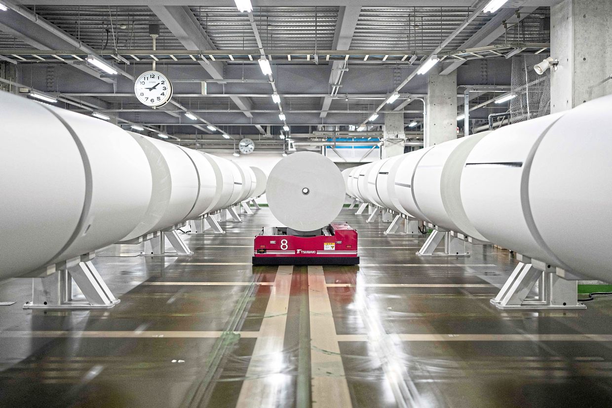 A robot carrying a roll of printing paper at the Kyoto Shimbun factory. Photo: AFP