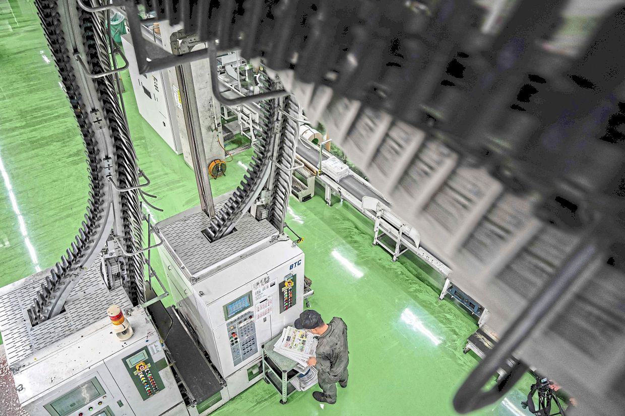 The inspection process to check the printing quality at the factory. Photo: AFP