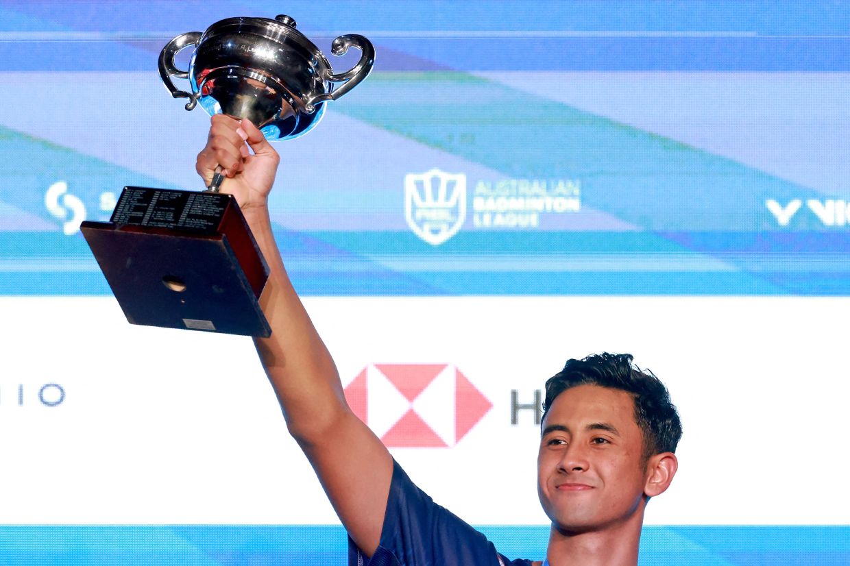 Indonesia's Alwi Farhan holds aloft the trophy winning at the Australian Open. - AFP
