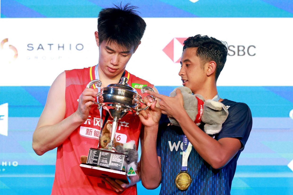 Indonesia's Alwi Farhan (right) holds the trophy with China's Dong Tianyao after their men's singles final at the Australian Open. - AFP.