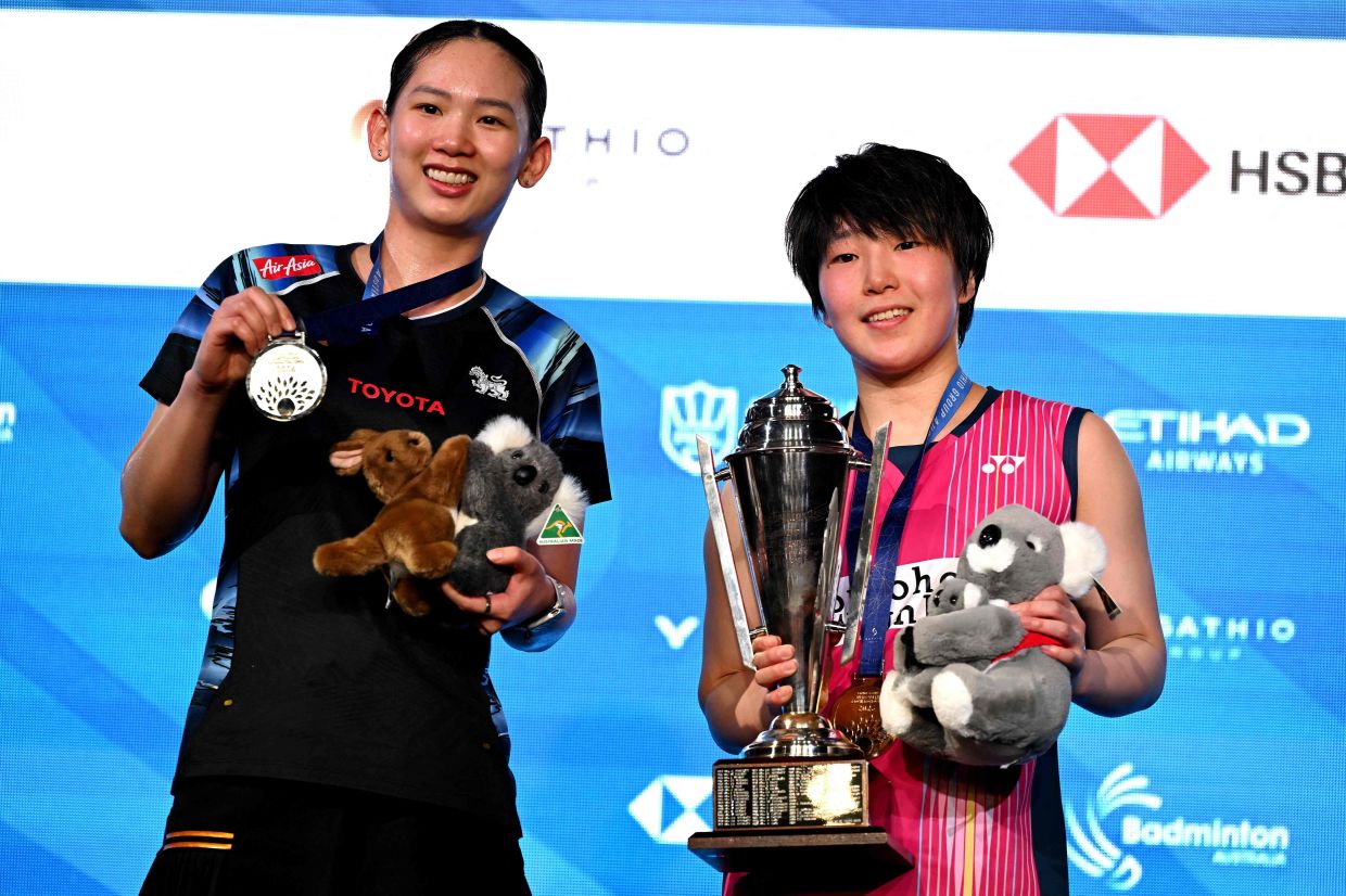 Winner Japan's Akane Yamaguchi (right) poses with runner-up Thailand's Pornpawee Chochuwong after their women's singles final at the Australian Open badminton tournament in Sydney on Sunday, June 14, 2026. -- Photo by Saeed KHAN / AFP