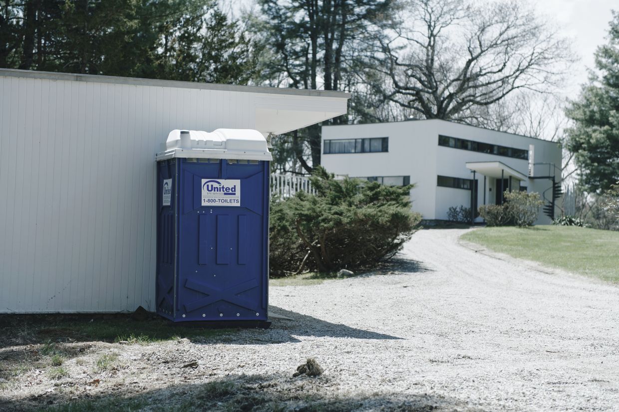 The blue, plastic portable toilet was the first thing visitors encountered upon arriving at the Gropius House property in recent decades.