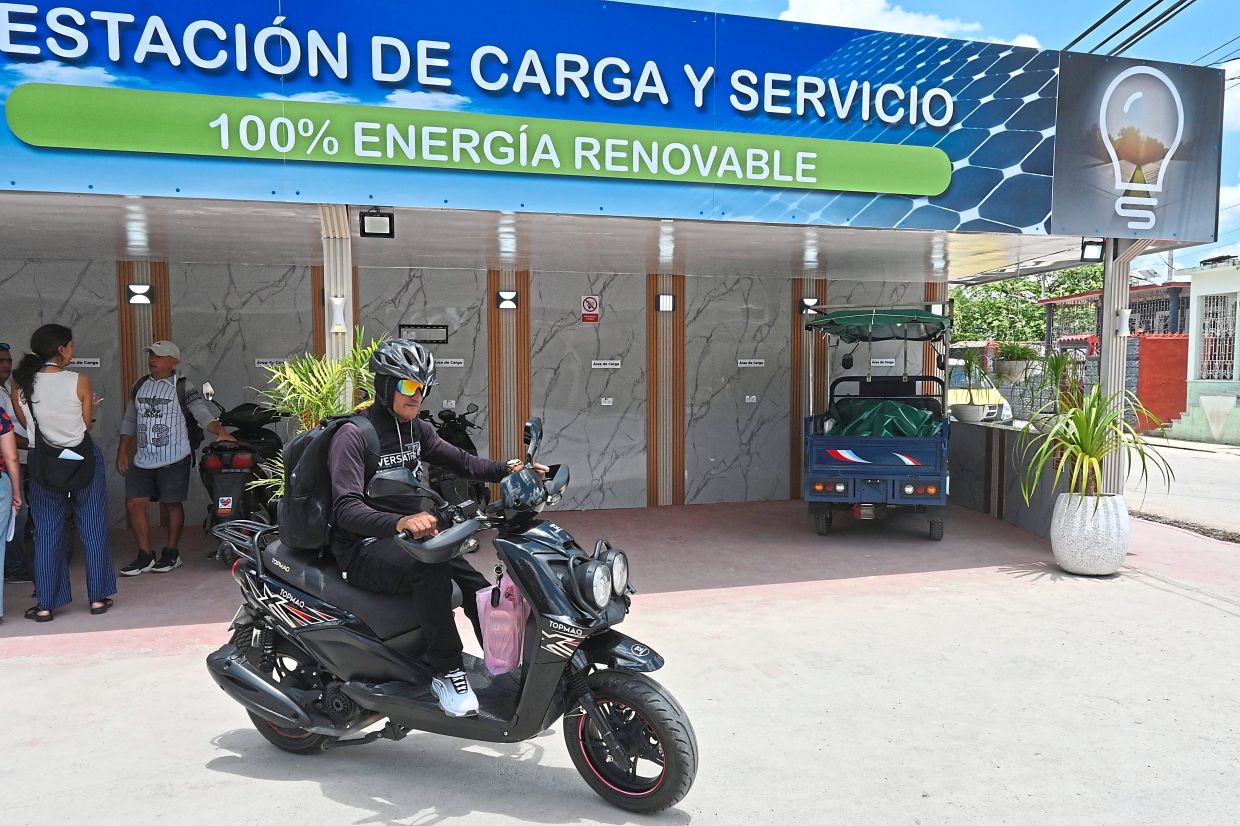 A motorcyclist leaves after recharging his electric bike at a charging station in Santa Clara.