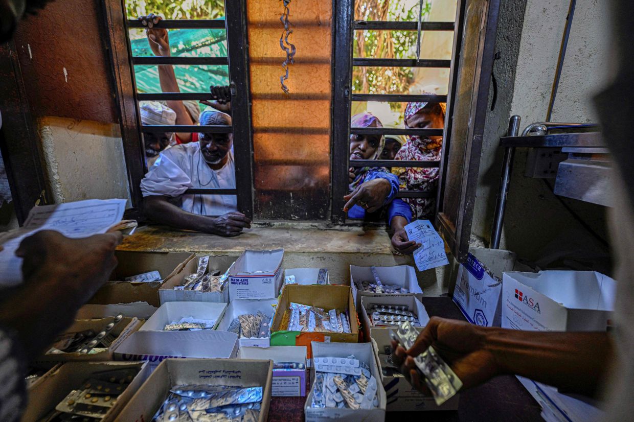 Sudanese people waiting to receive medicine provided by volunteers at Omdurman’s Al-Nao Educational Hospital, the capital’s main functioning health facility, amid the conflict. — AFP
