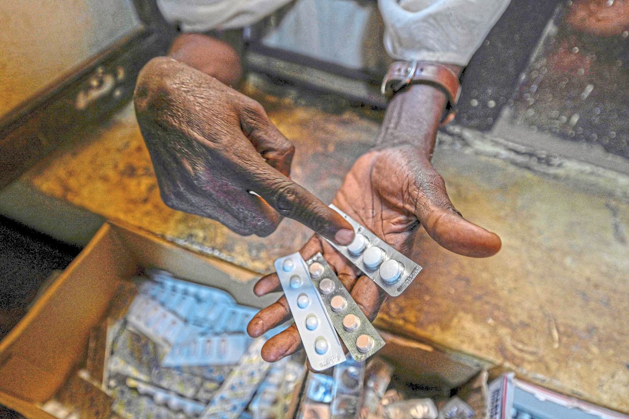 A man with the free medicine provided at Omdurman’s Al-Nao Educational Hospital in Sudan. — AFP