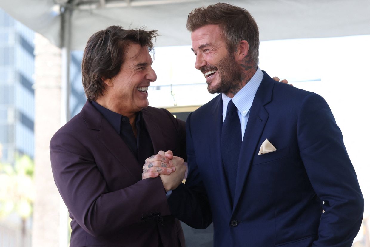 Tom Cruise and David Beckham greet during the unveiling ceremony of David Beckham's star on the Hollywood Walk of Fame on June 12, 2026. Photo: Reuters