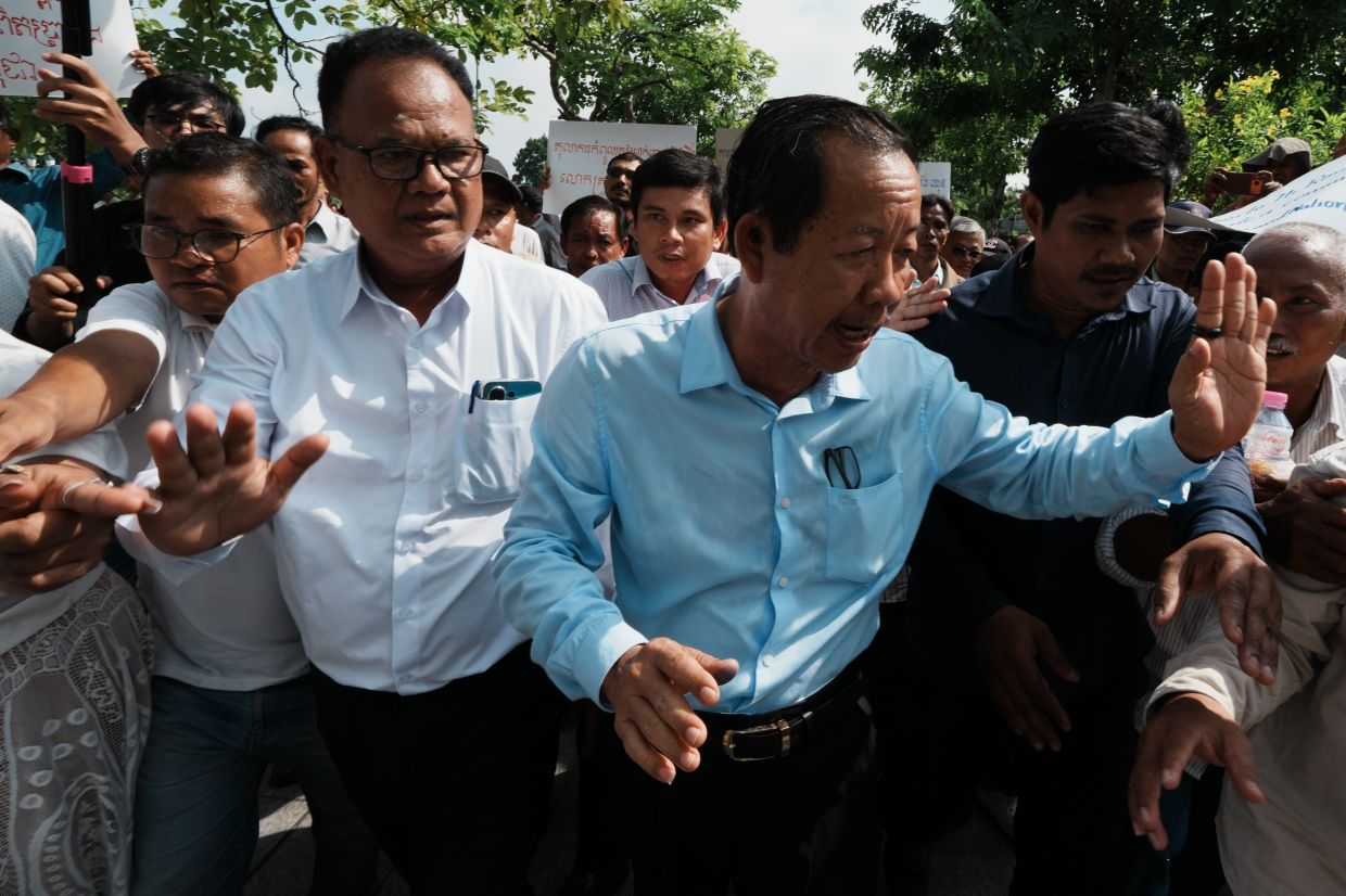 Rong Chhun, a prominent Cambodian opposition politician (right) leaves his Supreme Court hearing in Phnom Penh, Cambodia, on Monday, June 15, 2026. -- AP Photo/Heng Sinith
