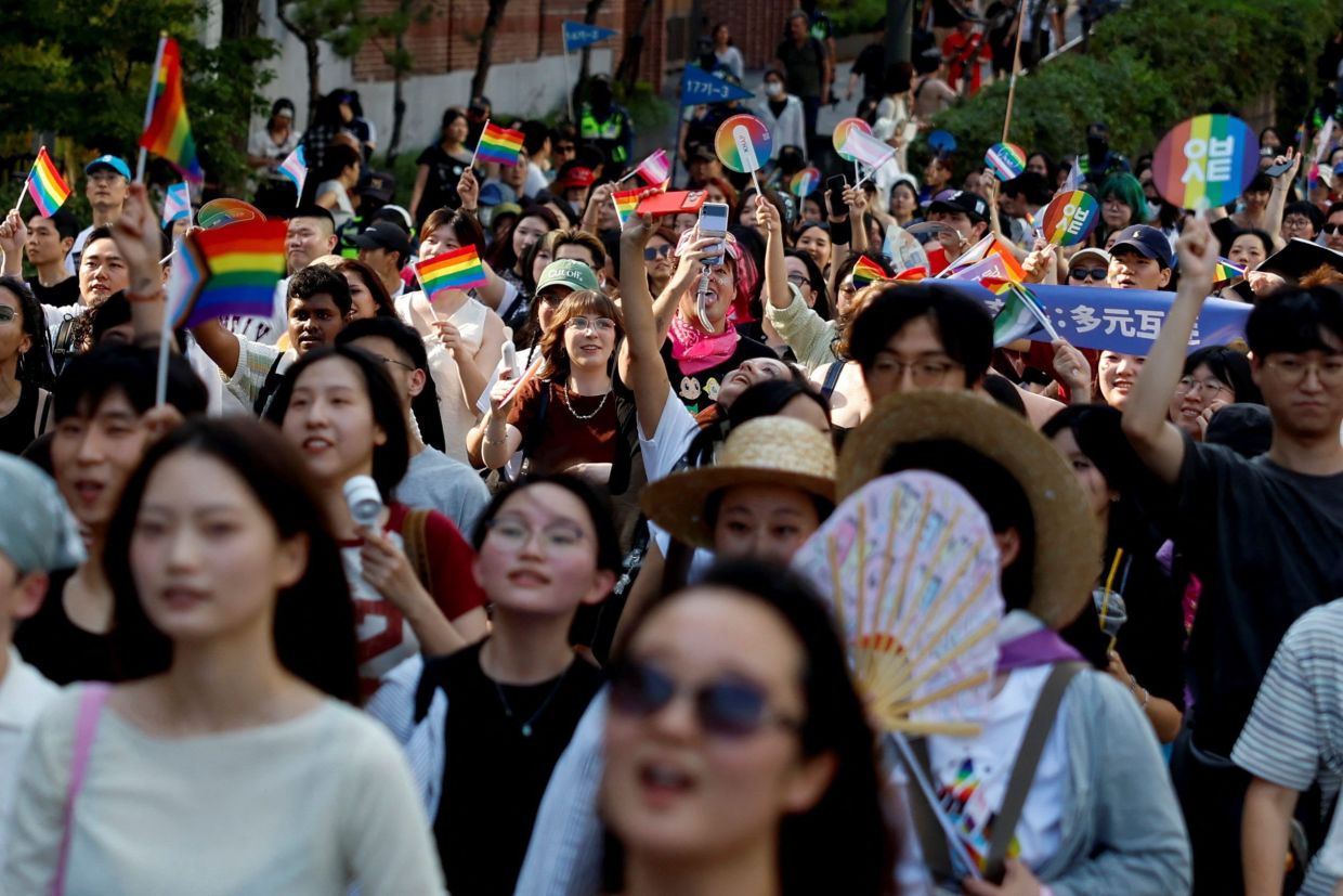 Participants wave rainbow flags as South Korea's LGBTQ community and supporters attend a pride parade during the Seoul Queer Culture Festival, in Seoul, South Korea, on Monday, June 13, 2026. -- Photo: REUTERS/Kim Soo-hyeon