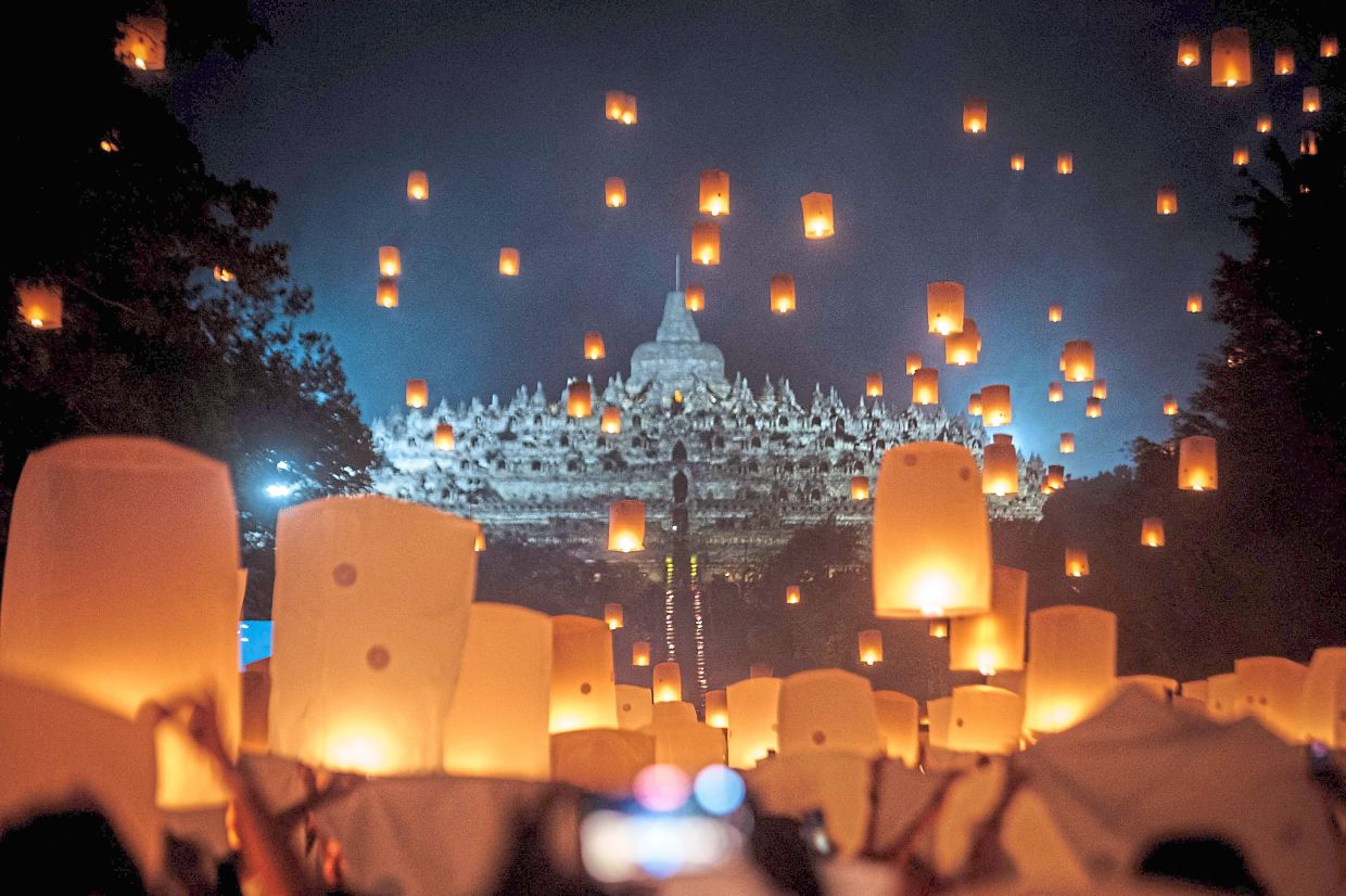 Lanterns glow and float against the night sky during Wesak celebrations in front of Borobudur Temple, the world’s largest Buddhist monument and a unesco World Heritage site, in Magelang, Central Java, Indonesia. — AFP