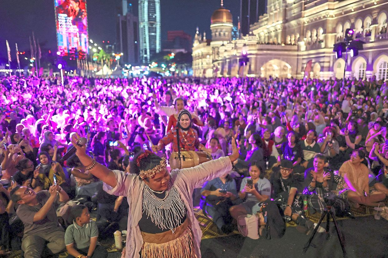 Members of the all-female Wayang Women troupe making their way through the crowd toward the stage to perform wayang kulit, the traditional shadow puppet theatre long dominated by men, in Kuala Lumpur. — Reuters