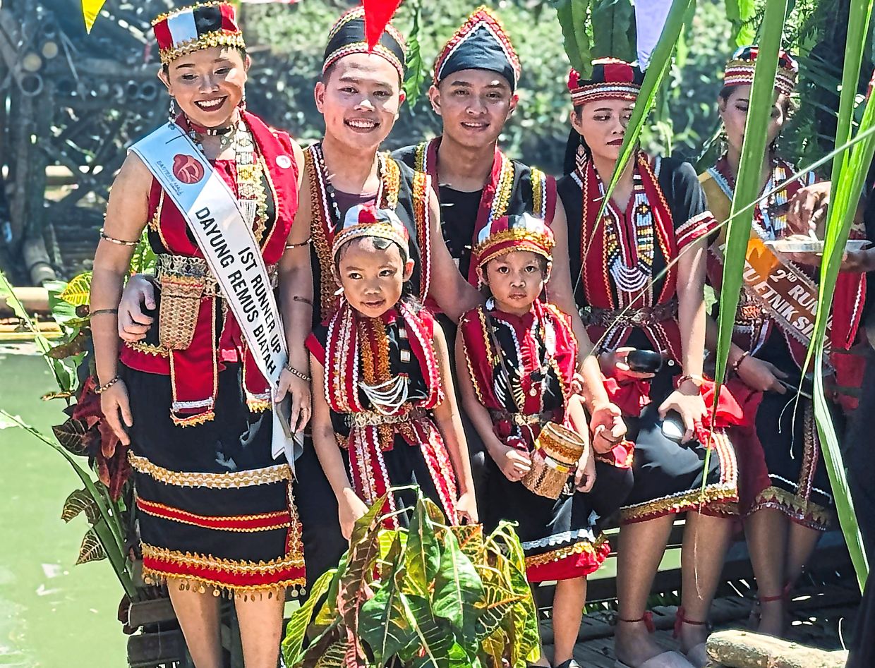 Bidayuh youths beaming with pride as they showcase striking traditional attire in black, red and golden yellow, adorned with intricate beaded accessories, during vibrant Gawai celebrations in KgSimpok, Padawan, Sarawak. — Bernama