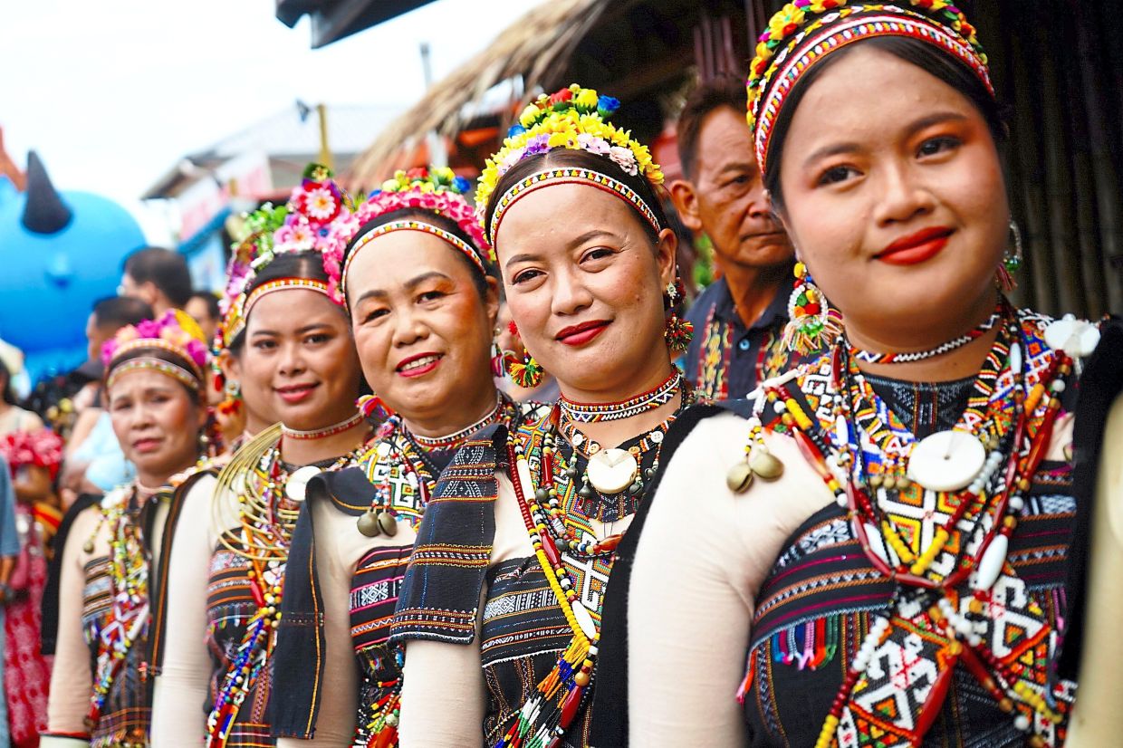Rungus dancers in ornate traditional attire standing poised to perform during Kaamatan celebrations in Penampang, sabah. — Bernama