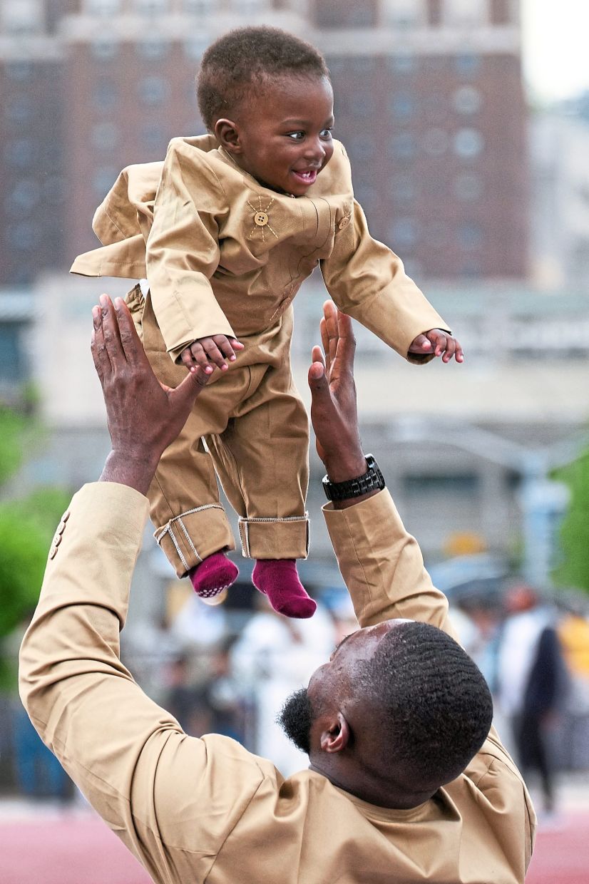 A man tossing a child into the air as Muslim worshippers attend prayers in the Bronx, New York City, the United States. — Reuters