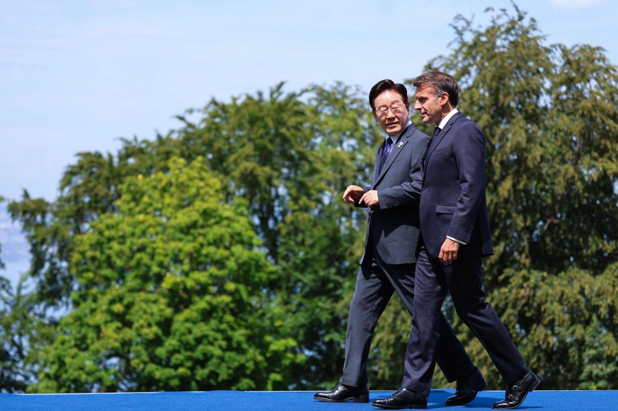 France's President Emmanuel Macron (right) welcomes South Korea's President Lee Jae-myung for the official greeting ahead of a work lunch as part of the G7 summit, in Evian, eastern France, on Tuesday, June 16, 2026. A G7 summit is set to take place June 15 to 17 in the French town of Evian-les-Bains near Switzerland, and it will be attended by country leaders as well as the EU's foreign policy chief and ministers from Brazil, Canada, the United Arab Emirates, and Turkey. -- Photo by Ludovic MARIN / AFP