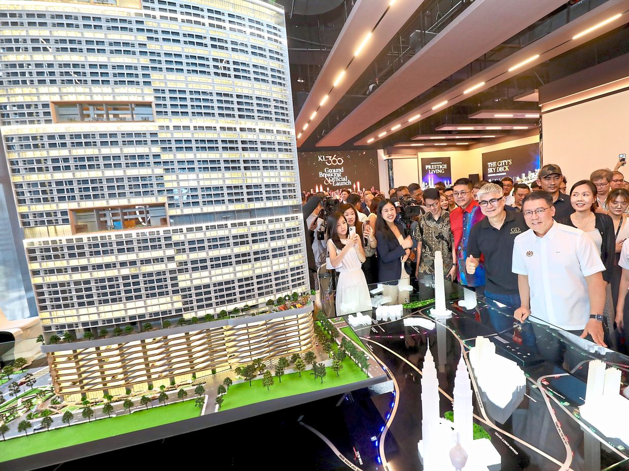 Nga (front row, right) and Wong (second right) looking at the scale model of GD Properties’ new project within Kuala Lumpur city centre.