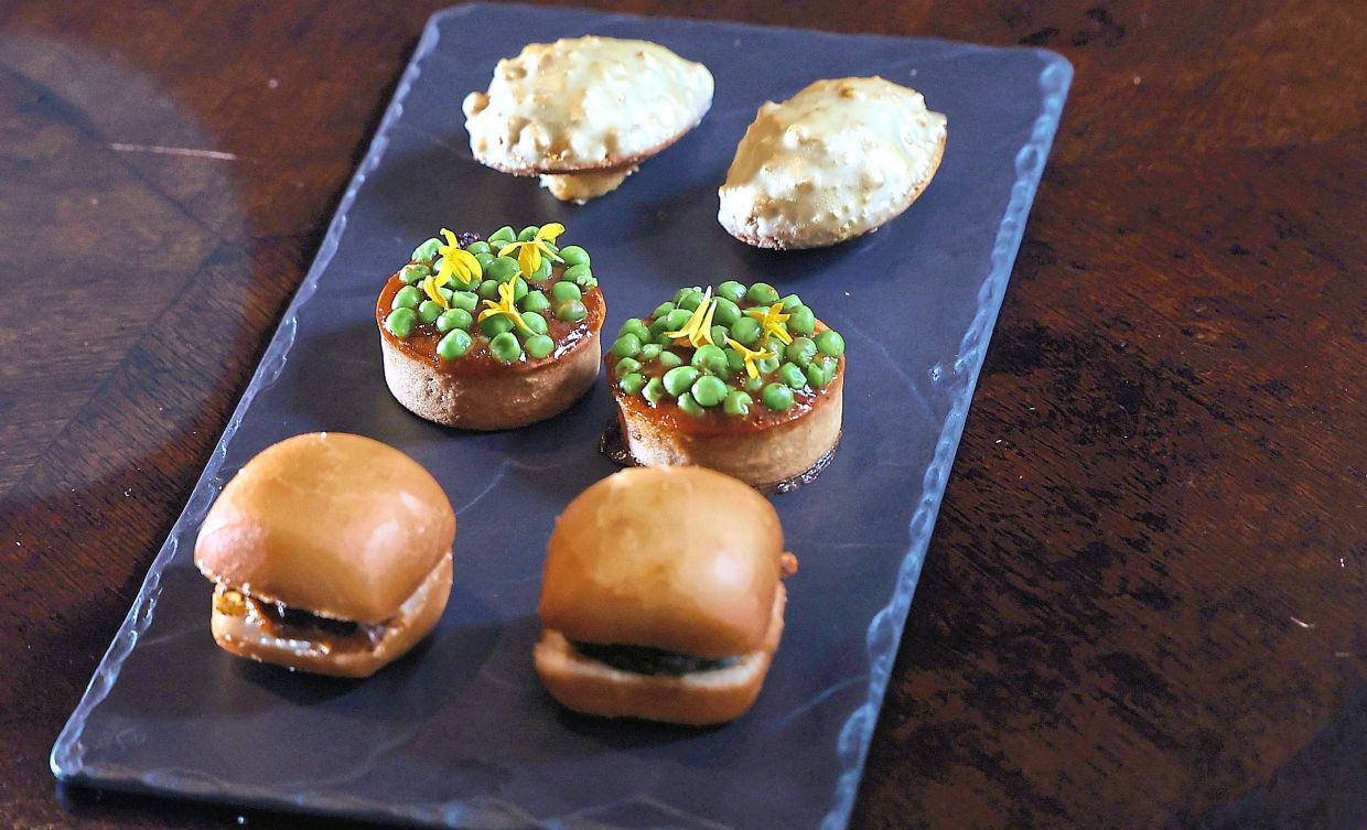 From top: Etre Patisserie’s madeleine (a jackfruit-infused sponge cake with salted egg glaze); The Ruma’s quiche (a Malay-style braised tomato chicken with peas); and sandwich (fried mantou with sambal ikan bilis and cucumber).