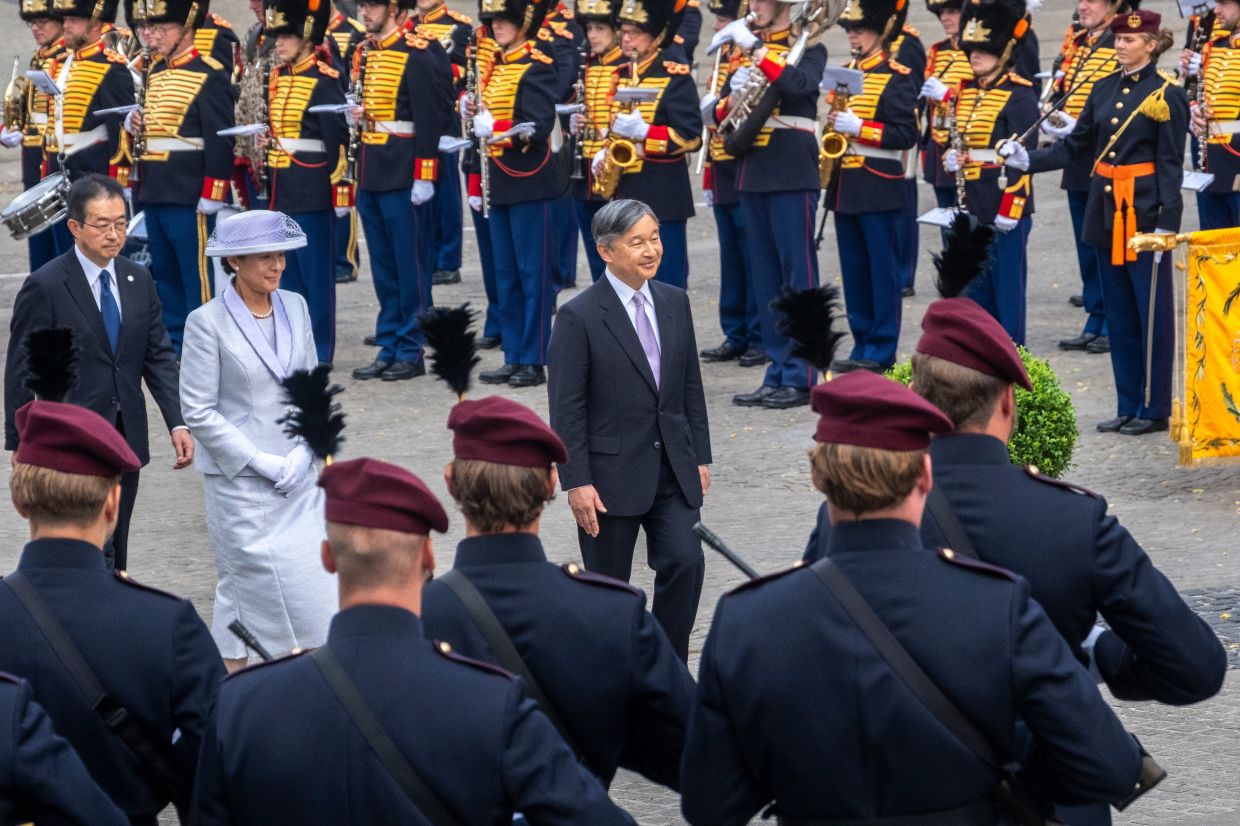 Japanese Emperor Naruhito and Empress Masako during the wreath-laying ceremony at the National Monument on Dam Square in Amsterdam, the Netherlands, on June 17, 2026. - AP