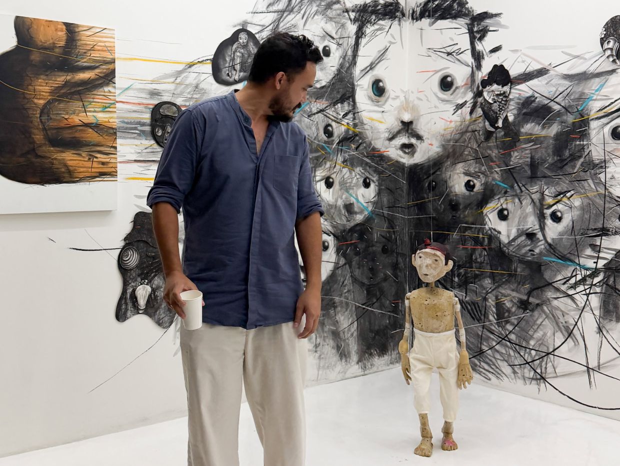A visitor pauses to view Jakarta-based contemporary artist and puppeteer Iwan Effendi’s work at 'Co-Presence', an exhibition marked by a distinctly theatrical sensibility. Photo: The Back Room