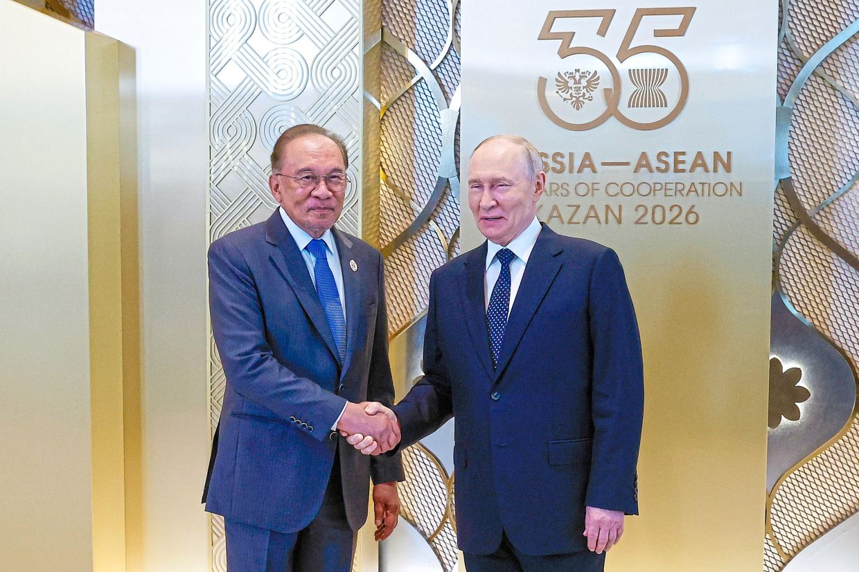 Productive meet-up: Anwar shaking hands with Putin before the Asean-Russia Commemorative Summit gala dinner at the Gallery Area of the Tatar State Academic Theatre in Kazan. — Bernama