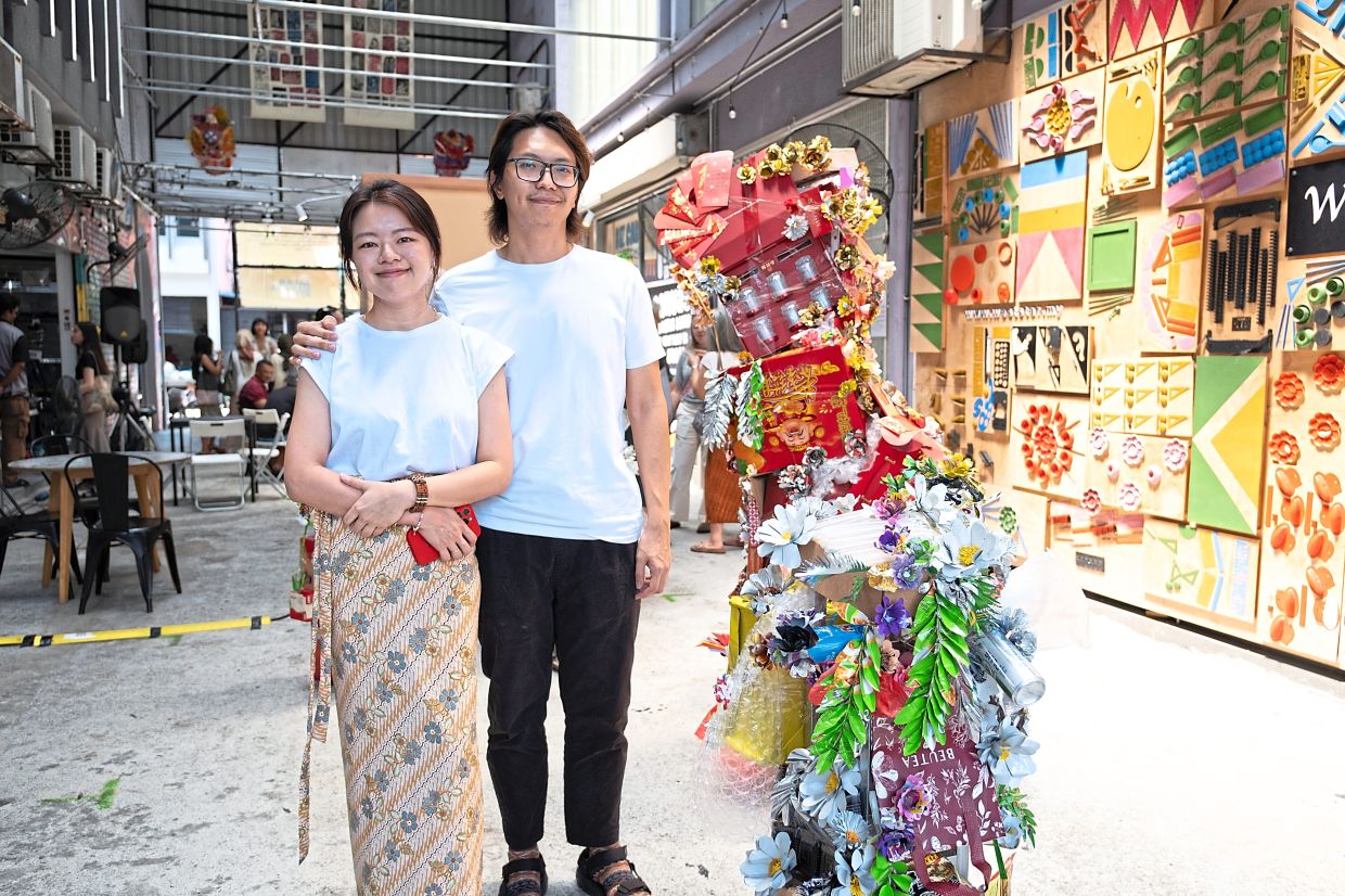 Artist duo Tan (left) and Lee, known as C02_karbondioksida, use discarded household materials in 'Seasons Of Bloom', an installation marking key life moments. Photo: A.Pop