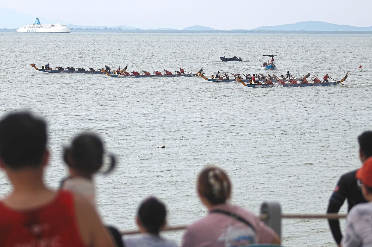 Spectators enjoying the competition at the Tanjung Bungah beachfront. 