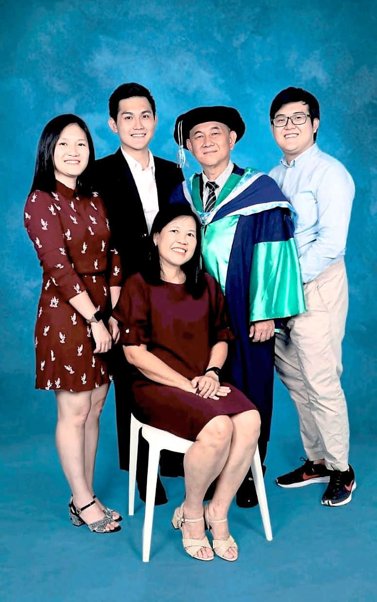 All together: Noh (seated back row, third from right) with his wife, children, their spouses and grandkids. (Left) Tay (second from right) with his wife and their three children.