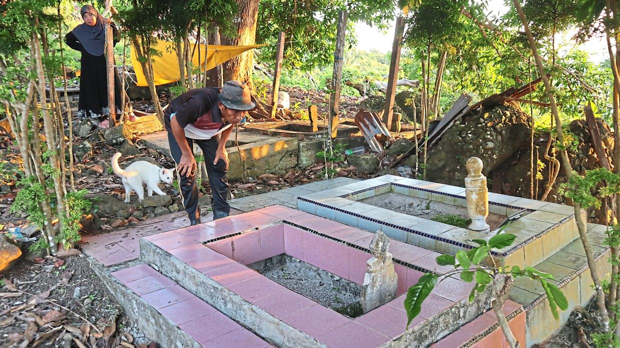 Residents showing family graves on Pulau Bodgaya, Semporna.