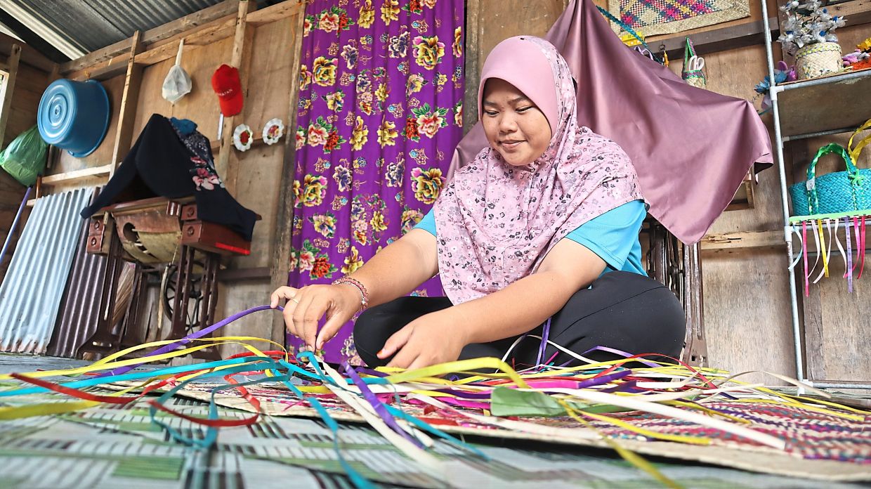 A villager weaving handicraft in Pulau Libaran.