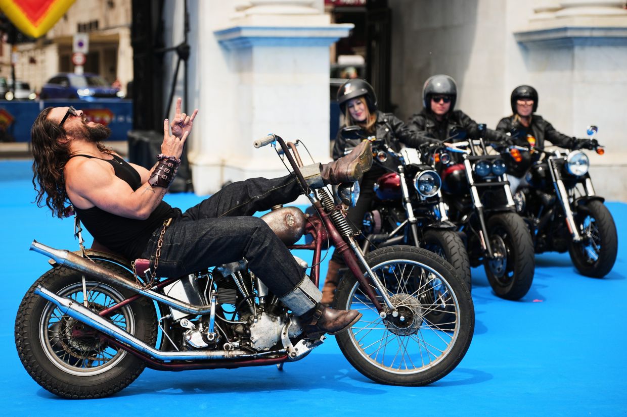 Jason Momoa (left) poses for photographers in front of Marble Arch at the photo call for the film 'Supergirl' in London. Photo: AP