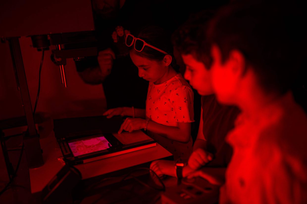 Children work in a darkroom during a workshop held as part of Fotohane Darkroom project in Mardin, southeastern Turkey. Photo: AFP