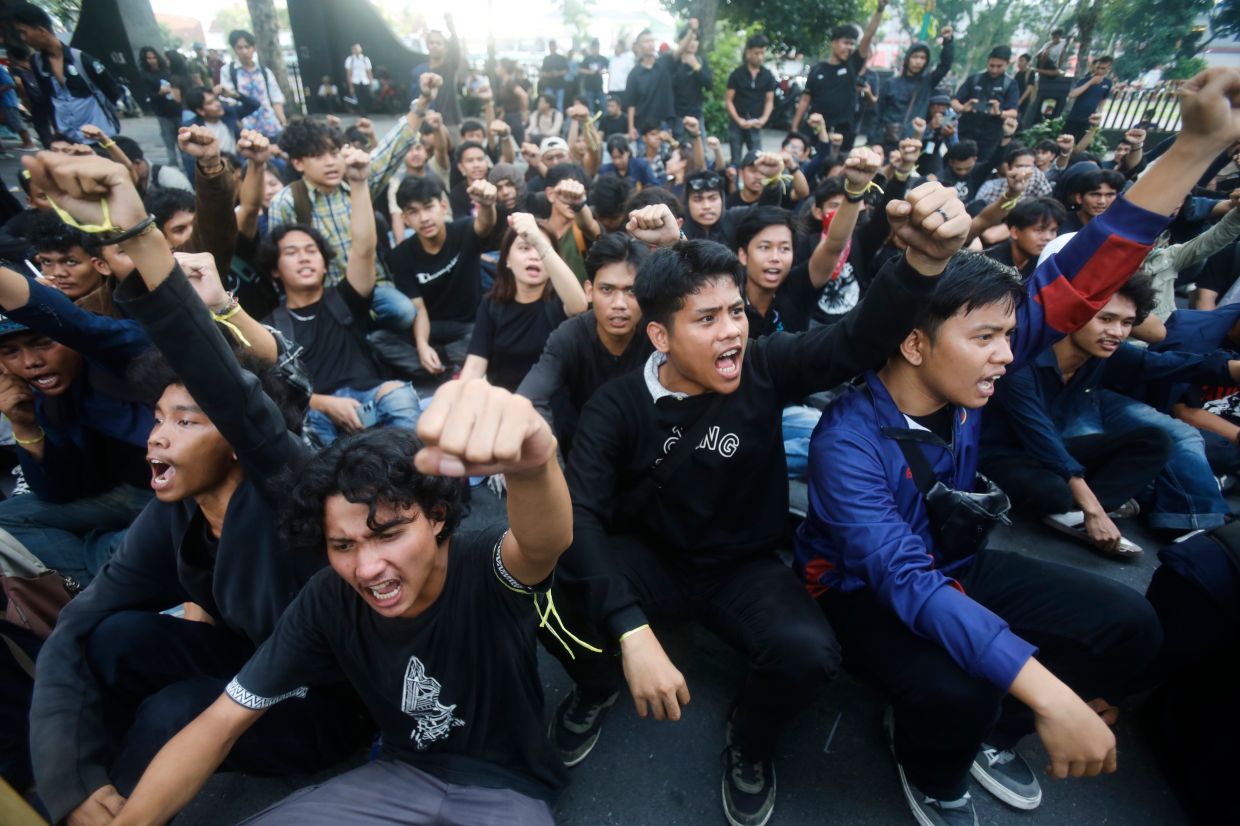 Student protesters are blocked by police officers during a rally against a fuel price hike, inefficient government spending, and military involvement in civilian affairs in Medan, North Sumatra, Indonesia, on Monday, June 22, 2026. -- AP Photo/Binsar Bakkara
