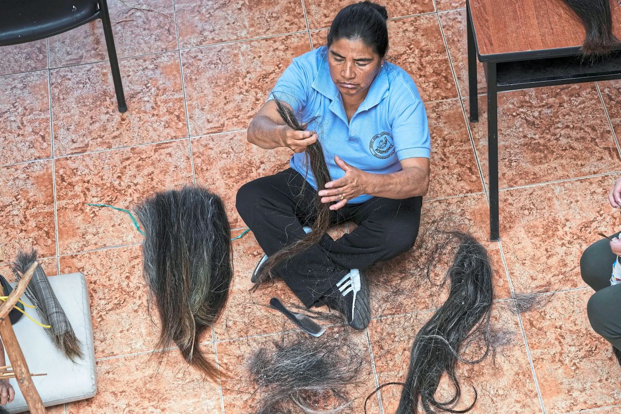 Leonor Cuje sorts horsehair before weaving sieves.