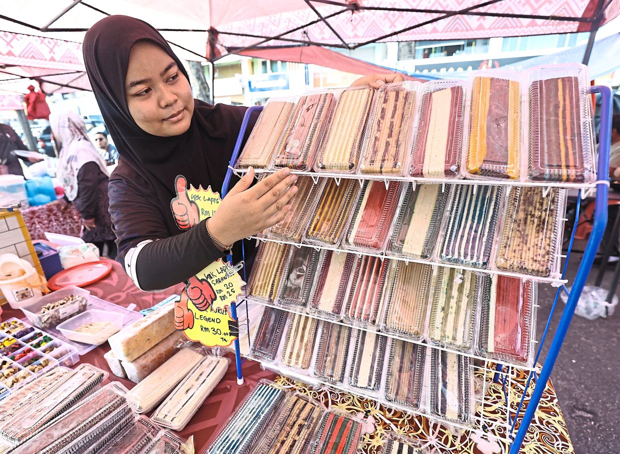 Ann Amira Yasmine selling a variety of ‘kek lapis’ Sarawak.