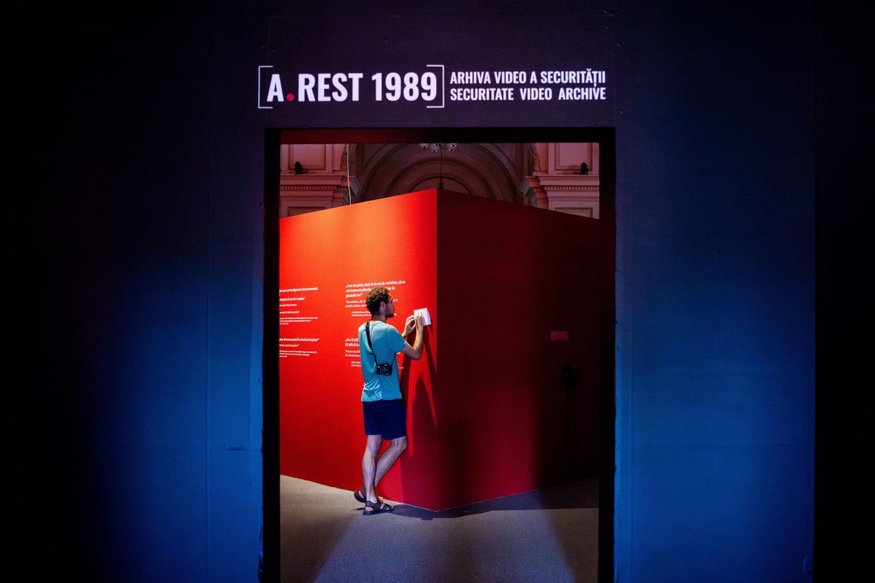 A man copies transcripts from Communist era surveillance tapes at the exhibition. Photo: AP