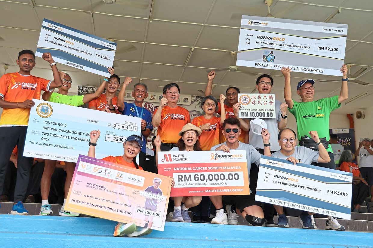 Chow (standing middle) celebrating with Lim on his right, and donors holding mock cheques to show their contributions to the good cause.